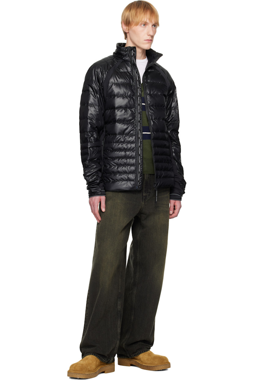Packable down-filled and quilted stretch recycled nylon ripstop jacket. Stretch fleece panels throughout.

· Packs into waist pocket
· Lightweight, water-repellent, and wind-resistant
· Stand collar
· Two-way zip closure
· Zip pockets
· Raglan sleeves
· Embroidered logo patch at sleeve
· Elasticized cuffs
· Reflective trim at back collar
· Patch pockets at interior
· Full nylon satin lining

Supplier color: Black

Fill: 90% goose down, 10% goose feather.