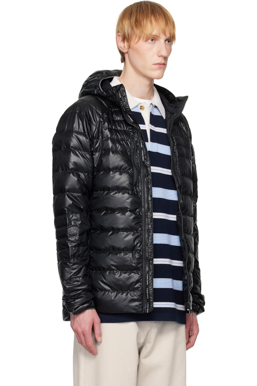 Packable down-filled and quilted stretch recycled nylon ripstop jacket. Stretch fleece panels throughout.
 
· Packs into waist pocket
· Lightweight, water-repellent, and wind-resistant
· Elasticized trim at hood and cuffs
· Stand collar
· Two-way zip closure
· Zip pockets
· Raglan sleeves
· Embroidered logo patch at sleeve
· Reflective trim at back collar
· Patch pockets at interior
· Full nylon satin lining

Supplier color: Black

Fill: 90% goose down, 10% goose feather.
