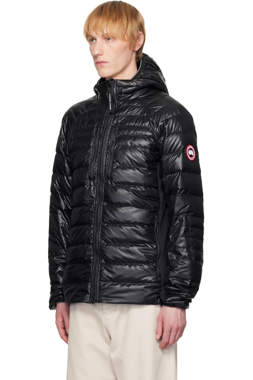 Packable down-filled and quilted stretch recycled nylon ripstop jacket. Stretch fleece panels throughout.
 
· Packs into waist pocket
· Lightweight, water-repellent, and wind-resistant
· Elasticized trim at hood and cuffs
· Stand collar
· Two-way zip closure
· Zip pockets
· Raglan sleeves
· Embroidered logo patch at sleeve
· Reflective trim at back collar
· Patch pockets at interior
· Full nylon satin lining

Supplier color: Black

Fill: 90% goose down, 10% goose feather.