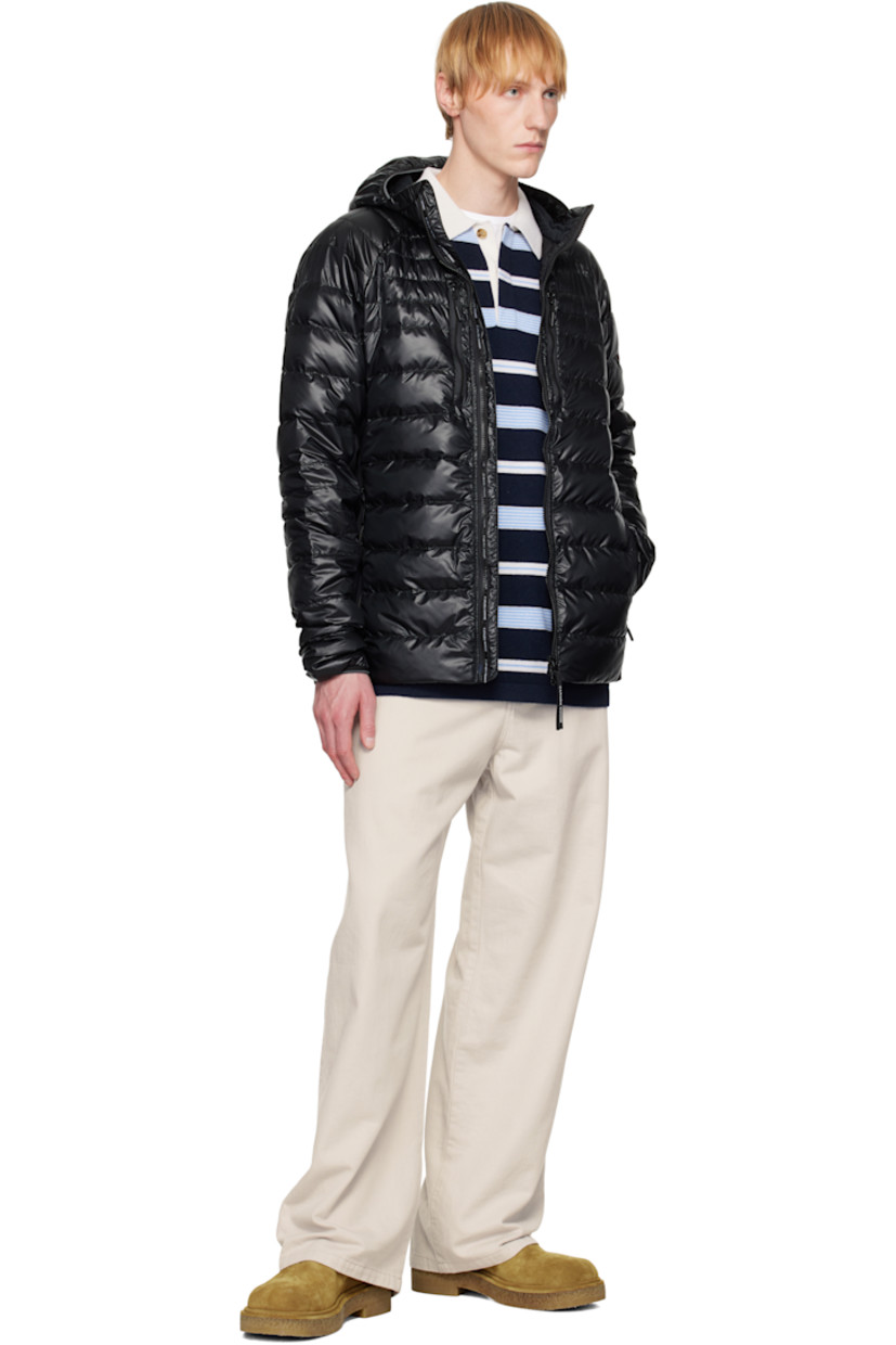 Packable down-filled and quilted stretch recycled nylon ripstop jacket. Stretch fleece panels throughout.
 
· Packs into waist pocket
· Lightweight, water-repellent, and wind-resistant
· Elasticized trim at hood and cuffs
· Stand collar
· Two-way zip closure
· Zip pockets
· Raglan sleeves
· Embroidered logo patch at sleeve
· Reflective trim at back collar
· Patch pockets at interior
· Full nylon satin lining

Supplier color: Black

Fill: 90% goose down, 10% goose feather.