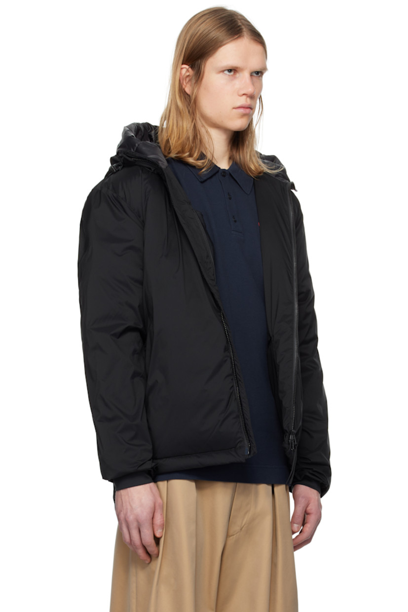Packable down-filled nylon ripstop jacket. Lightweight, water-repellent, and wind-resistant.

· Bungee-style drawstring at hood
· Stand collar
· Two-way zip closure
· Zip pockets
· Concealed bungee-style drawstring at droptail hem
· Embroidered logo patch at sleeve
· Power Stretch® jersey cuffs
· Zip pocket and patch pocket at interior
· Partial ripstop and quilted satin lining

Part of the Black Label collection.

Supplier color: Black

Fill: 90% duck down, 10% duck feathers.