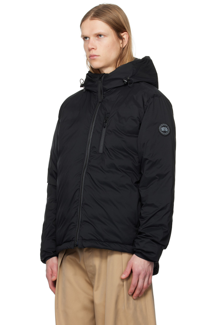 Packable down-filled nylon ripstop jacket. Lightweight, water-repellent, and wind-resistant.

· Bungee-style drawstring at hood
· Stand collar
· Two-way zip closure
· Zip pockets
· Concealed bungee-style drawstring at droptail hem
· Embroidered logo patch at sleeve
· Power Stretch® jersey cuffs
· Zip pocket and patch pocket at interior
· Partial ripstop and quilted satin lining

Part of the Black Label collection.

Supplier color: Black

Fill: 90% duck down, 10% duck feathers.