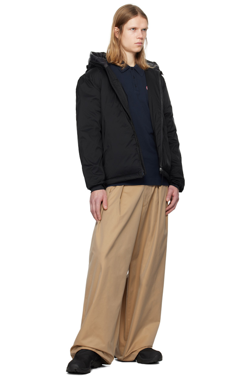 Packable down-filled nylon ripstop jacket. Lightweight, water-repellent, and wind-resistant.

· Bungee-style drawstring at hood
· Stand collar
· Two-way zip closure
· Zip pockets
· Concealed bungee-style drawstring at droptail hem
· Embroidered logo patch at sleeve
· Power Stretch® jersey cuffs
· Zip pocket and patch pocket at interior
· Partial ripstop and quilted satin lining

Part of the Black Label collection.

Supplier color: Black

Fill: 90% duck down, 10% duck feathers.