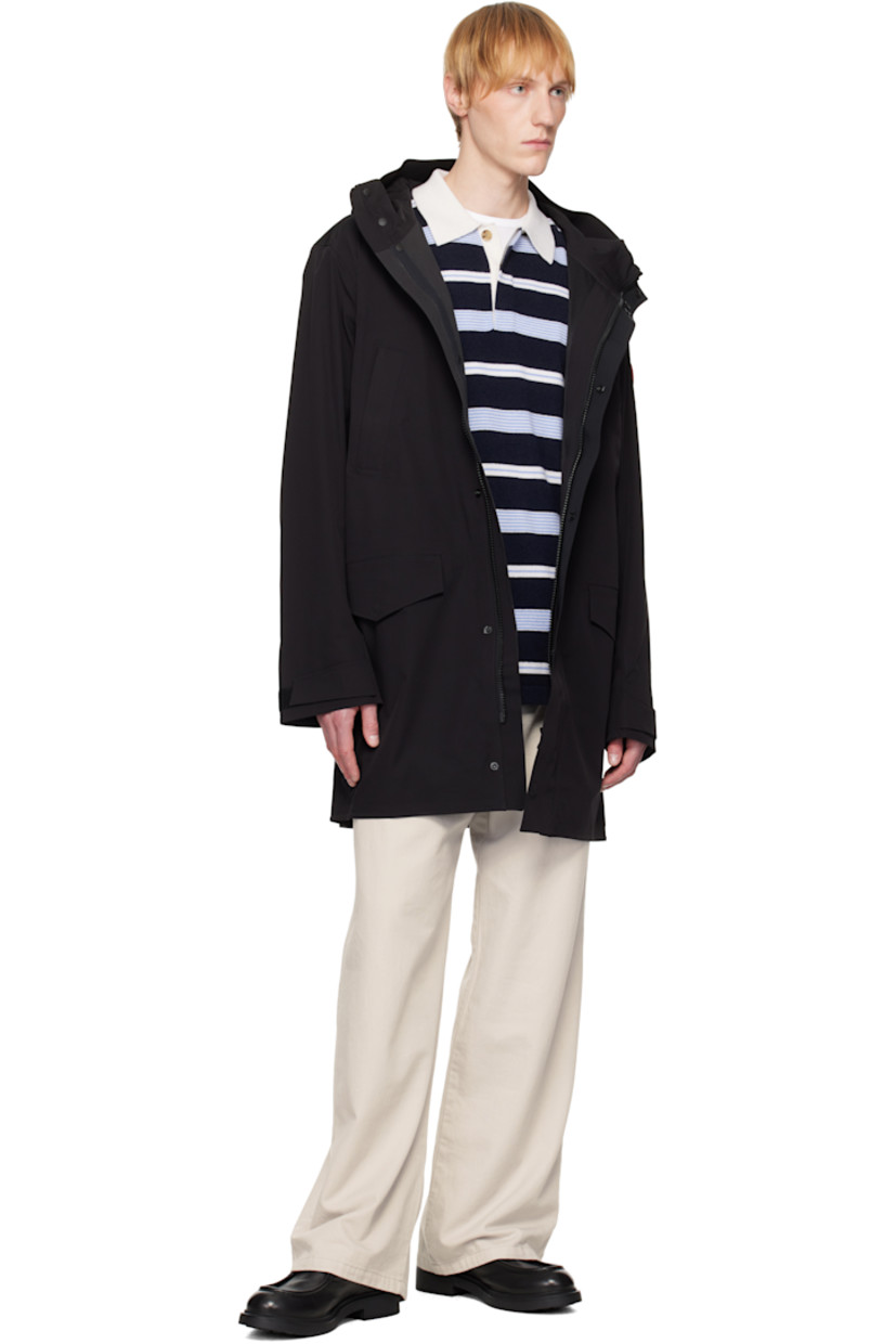 Waterproof stretch recycled nylon taffeta rain coat.

· Bungee-style drawstring at hood
· Stand collar
· Two-way zip closure with press-stud placket
· Zip and flap pockets
· Rubberized logo patch at sleeve
· Velcro tab at cuffs
· Storm flap at back
· Taped seams and zip pocket at interior
· Full bonded jersey and mesh lining

Supplier color: Black