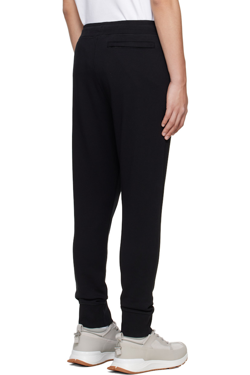 French terry sweatpants.

· Drawstring at elasticized waistband
· Rib-knit waistband and cuffs
· Three-pocket styling
· Embroidered logo patch at front

Supplier color: Black