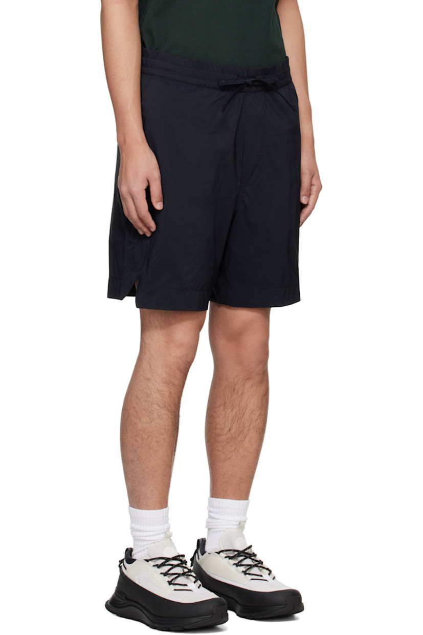 Packable nylon ripstop shorts.

· Drawstring at elasticized waistband
· Three-pocket styling
· Mock fly
· Vented outseams
· Embroidered logo patch at back
· Packs into back zip pocket
· Full nylon taffeta lining

Supplier color: Black