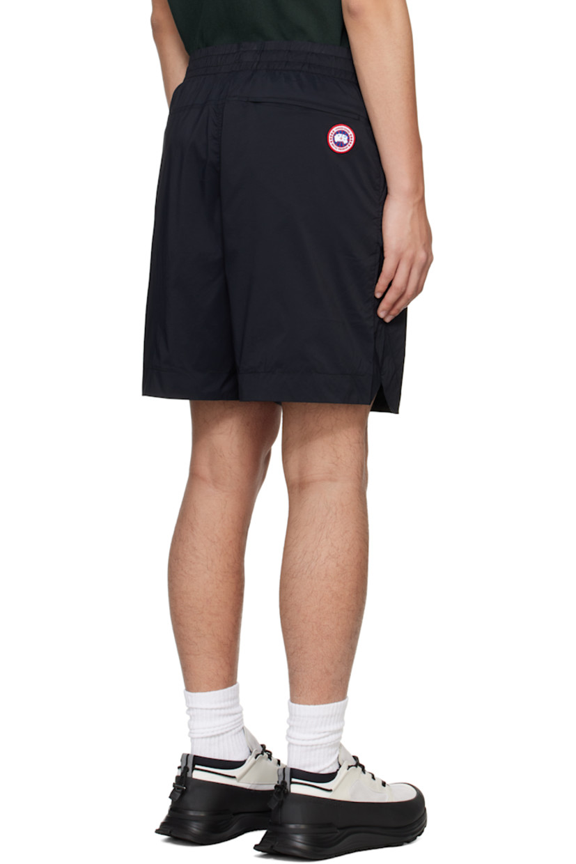 Packable nylon ripstop shorts.

· Drawstring at elasticized waistband
· Three-pocket styling
· Mock fly
· Vented outseams
· Embroidered logo patch at back
· Packs into back zip pocket
· Full nylon taffeta lining

Supplier color: Black