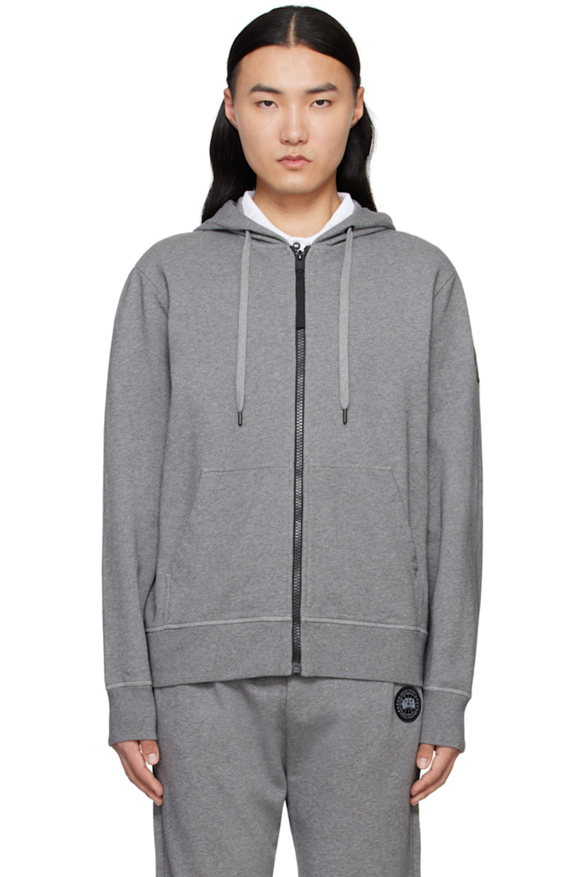 Cotton French terry hoodie.

· Drawstring at hood
· Zip closure
· Patch pockets
· Rib-knit hem and cuffs
· Embroidered logo patch at sleeve

Part of the Black Label collection.

Supplier color: Stone Heather