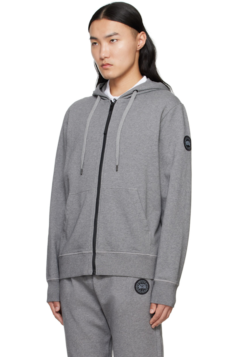 Cotton French terry hoodie.

· Drawstring at hood
· Zip closure
· Patch pockets
· Rib-knit hem and cuffs
· Embroidered logo patch at sleeve

Part of the Black Label collection.

Supplier color: Stone Heather