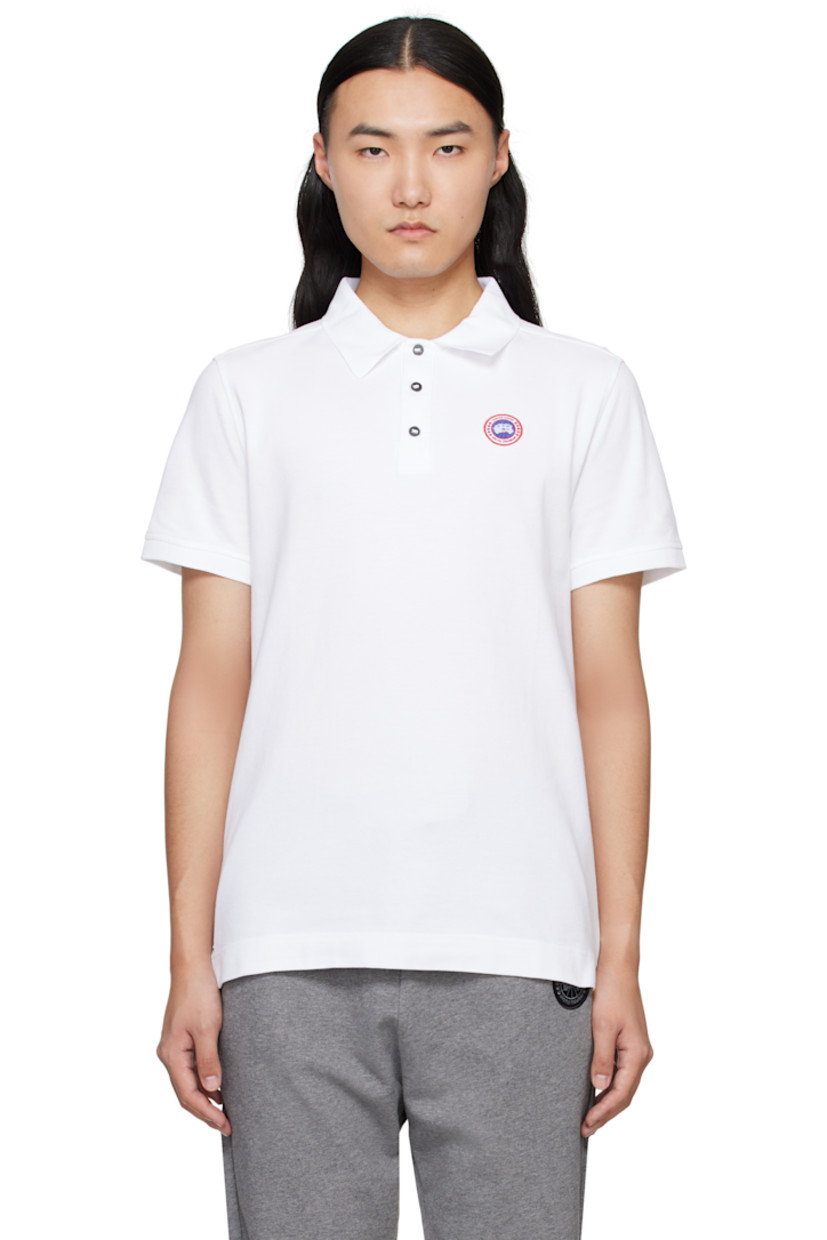 Cotton piqué polo.

· Rib-knit spread collar and cuffs
· Three-button placket
· Embroidered logo patch at chest
· Tennis-tail hem

Supplier color: White