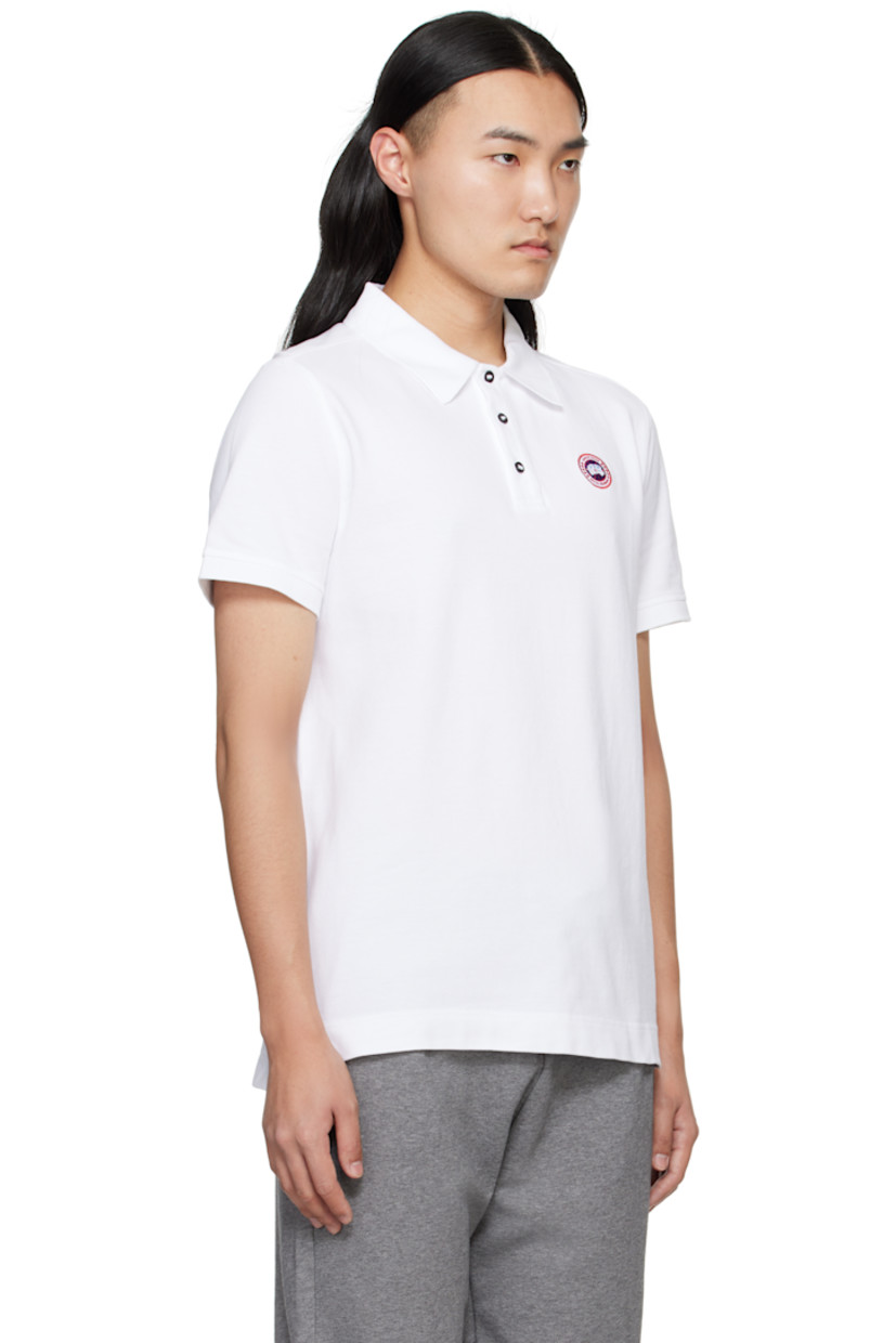 Cotton piqué polo.

· Rib-knit spread collar and cuffs
· Three-button placket
· Embroidered logo patch at chest
· Tennis-tail hem

Supplier color: White