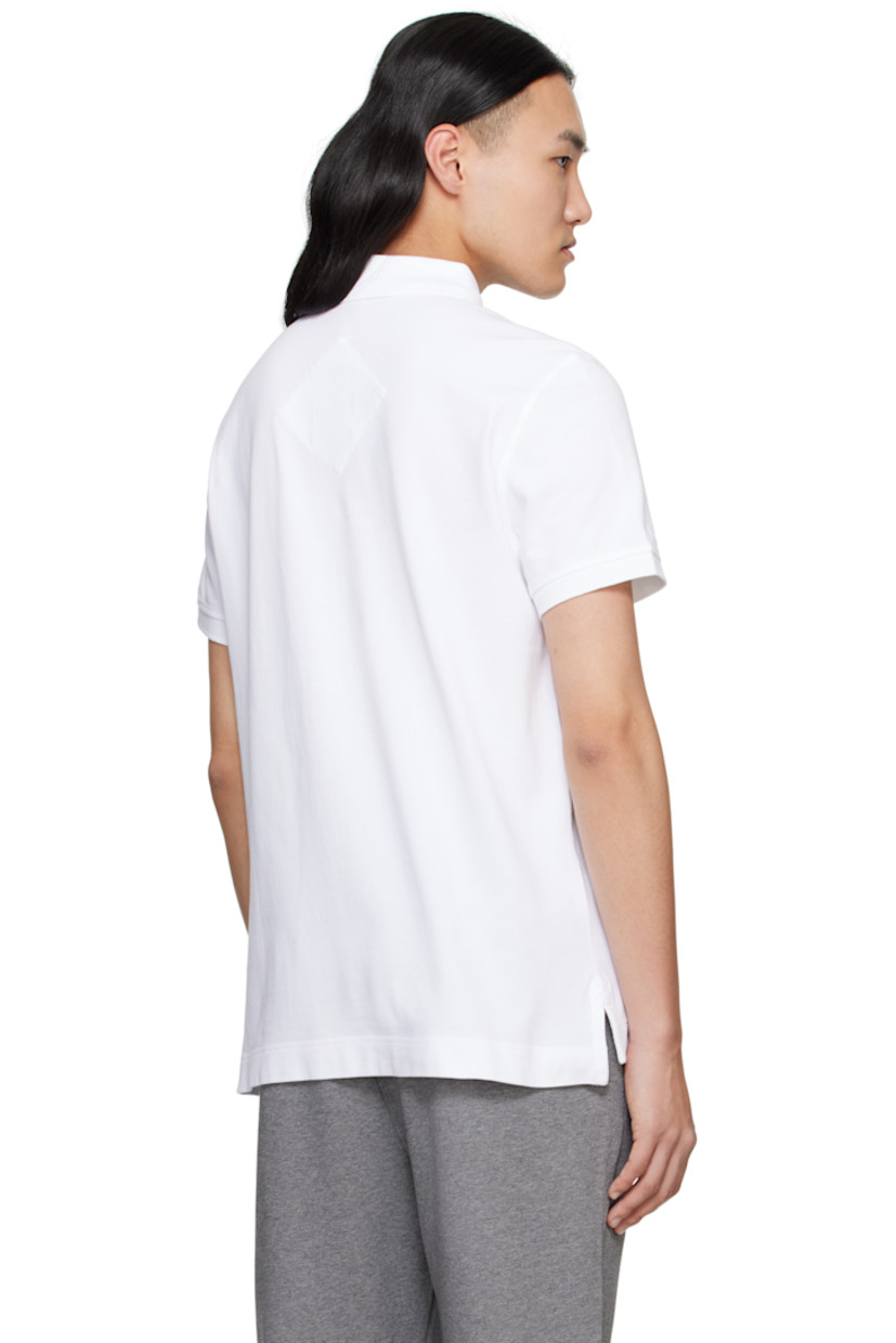 Cotton piqué polo.

· Rib-knit spread collar and cuffs
· Three-button placket
· Embroidered logo patch at chest
· Tennis-tail hem

Supplier color: White