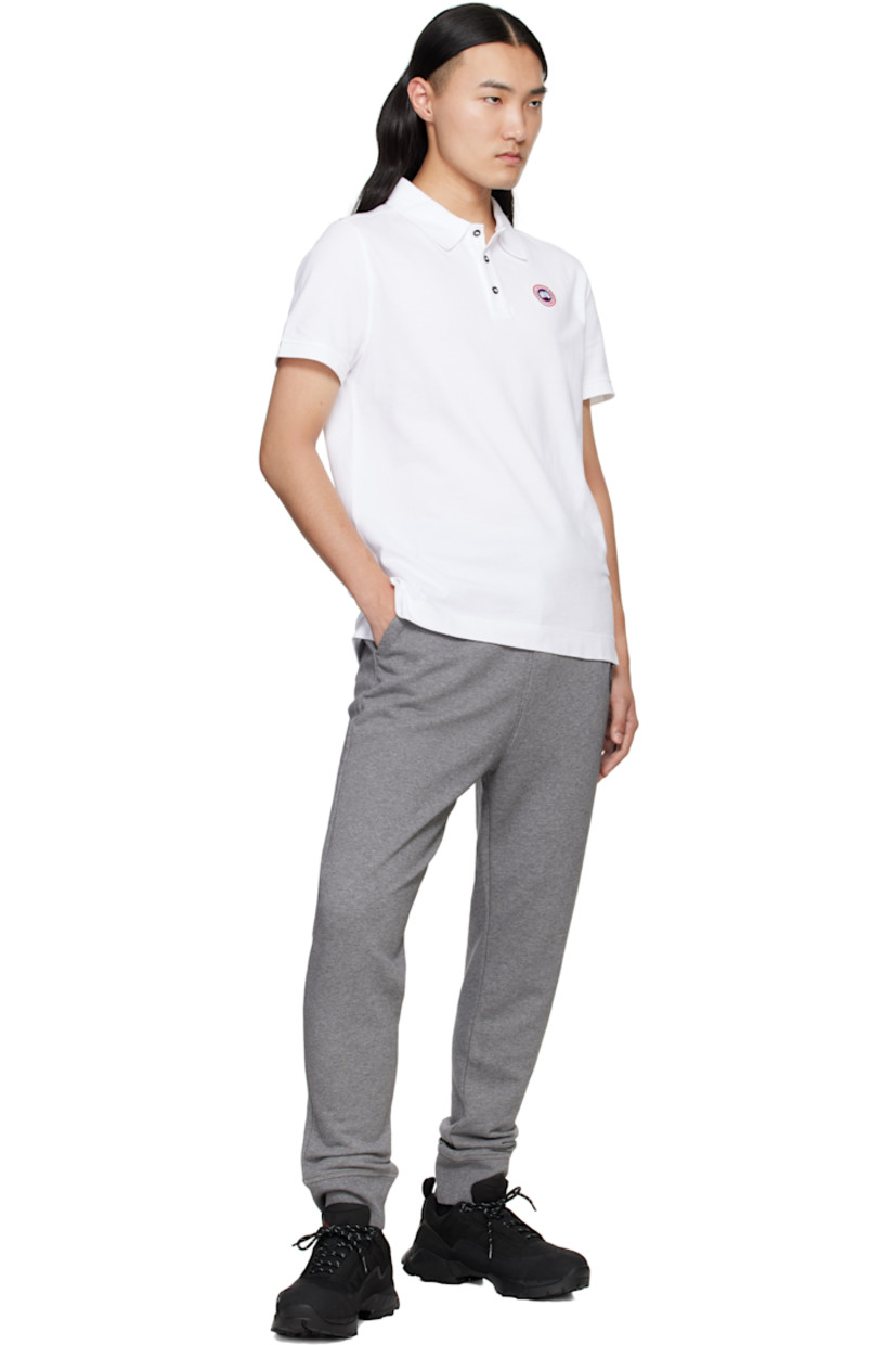 Cotton piqué polo.

· Rib-knit spread collar and cuffs
· Three-button placket
· Embroidered logo patch at chest
· Tennis-tail hem

Supplier color: White