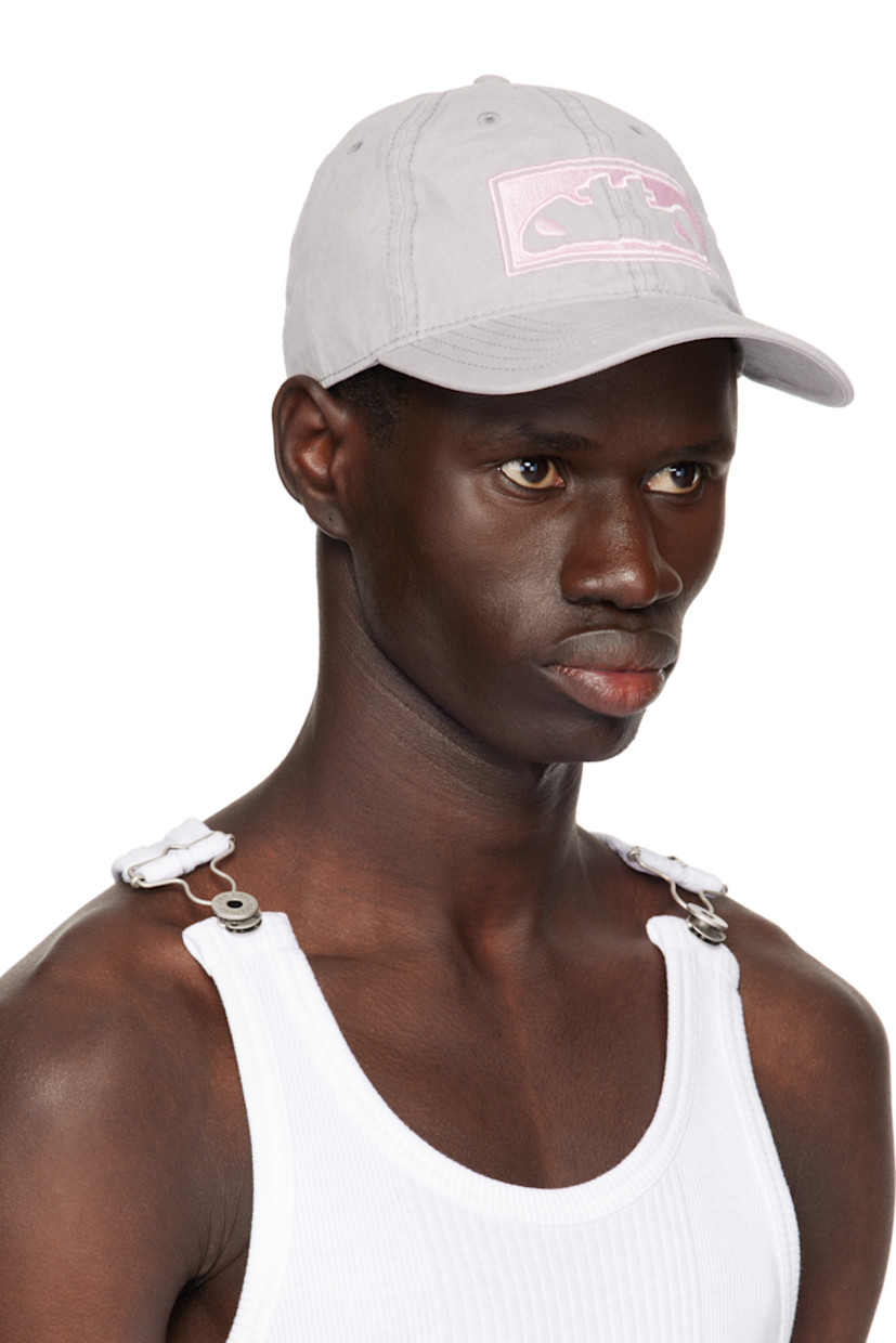 Cotton canvas cap in gray.

· Embroidered eyelets at crown
· Embroidered logo at face, side, and back
· Curved brim
· Cinch strap at back
· Twill browband
· Unlined

Supplier color: Grey/Pink