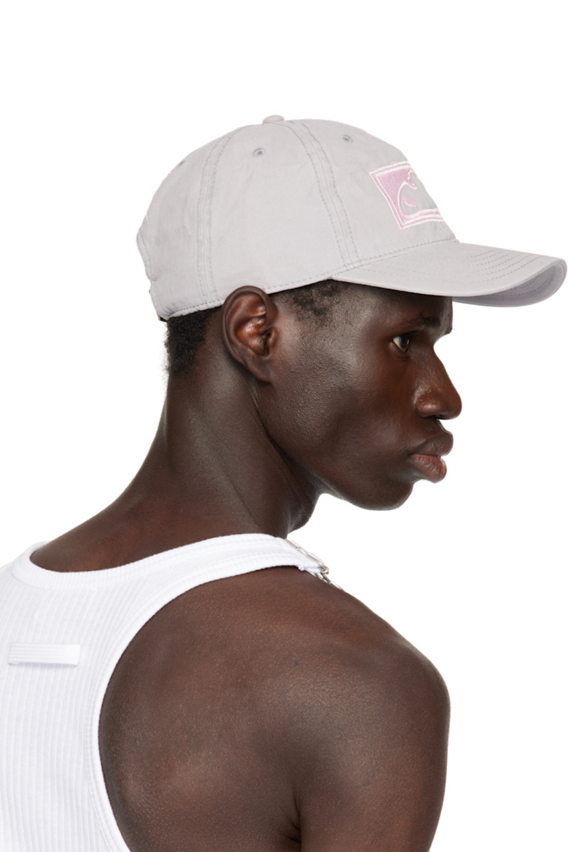 Cotton canvas cap in gray.

· Embroidered eyelets at crown
· Embroidered logo at face, side, and back
· Curved brim
· Cinch strap at back
· Twill browband
· Unlined

Supplier color: Grey/Pink