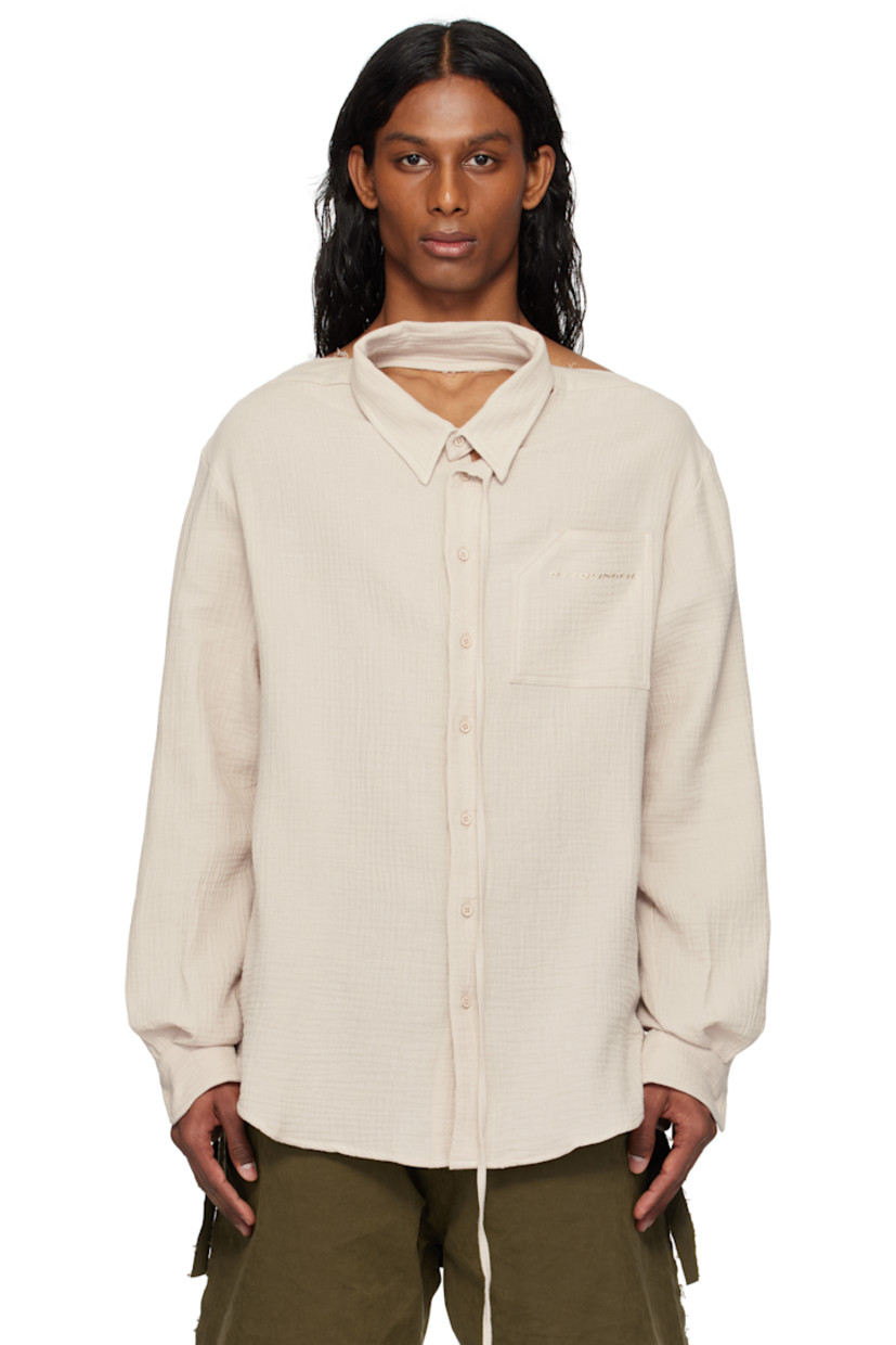 Cotton muslin shirt. 

· Raw edge at boat neck 
· Extended trim at spread collar 
· Button closure
· Logo embroidered at patch pocket
· Shirttail hem
· Dropped shoulders
· Buttoned barrel cuffs
· Twin pleats at back yoke

Supplier color: Stone