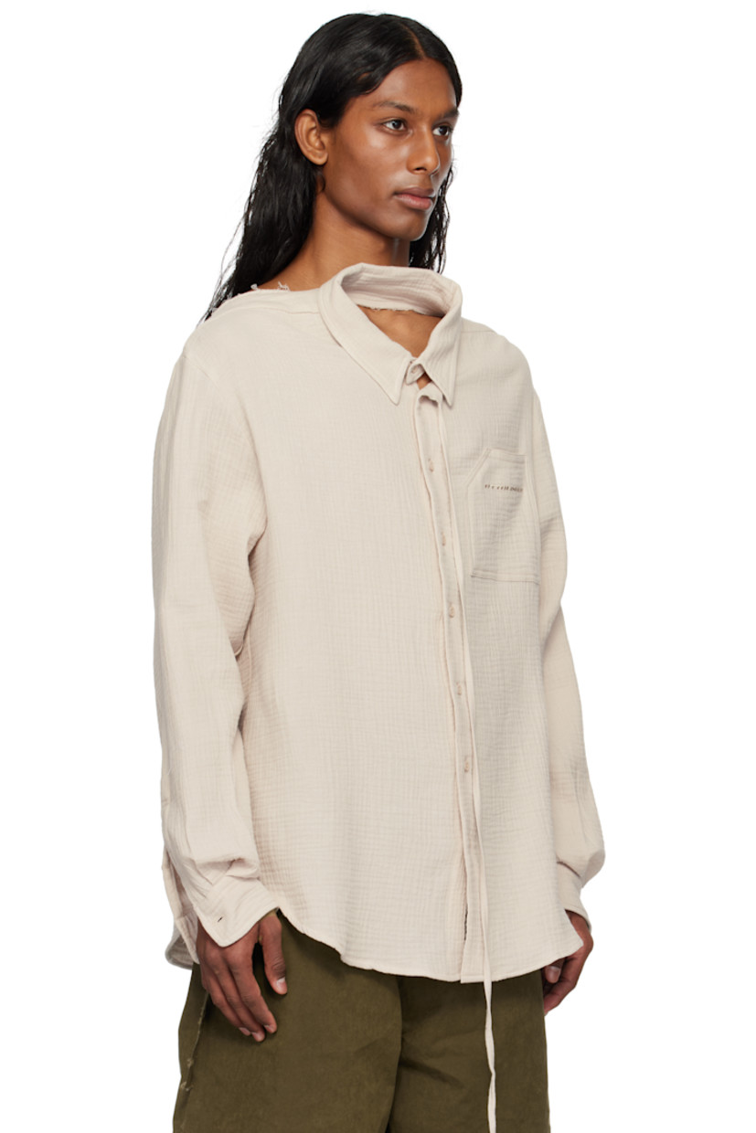 Cotton muslin shirt. 

· Raw edge at boat neck 
· Extended trim at spread collar 
· Button closure
· Logo embroidered at patch pocket
· Shirttail hem
· Dropped shoulders
· Buttoned barrel cuffs
· Twin pleats at back yoke

Supplier color: Stone