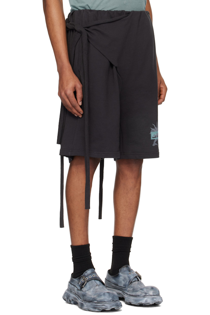 Handcrafted organic cotton French terry shorts. Rolled raw edges throughout.

· Wrap construction
· Self-tie fastening at elasticized waistband
· Two-pocket styling
· Logo graphic printed at cuff

Supplier color: Black