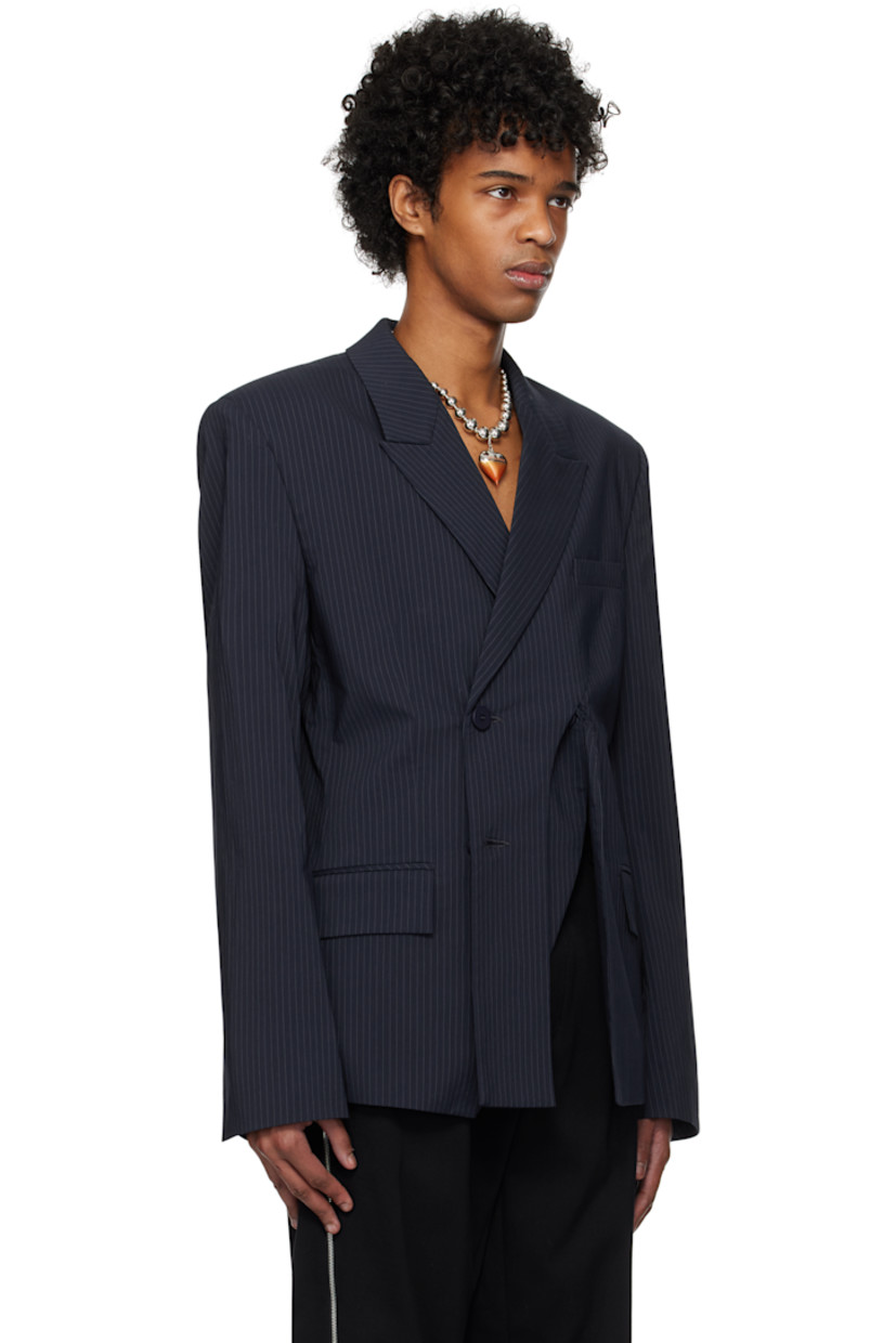 Stretch cotton- and nylon-blend twill blazer. Pinstripes throughout. 

· Peaked lapel
· Button closure
· Welt pocket at chest
· Curved slit at front
· Flap pockets at waist
· Padded shoulders
· Vent at cuffs
· Twin vents at back hem 
· Welt pocket at interior 
· Full satin lining 

Supplier color: Navy striped