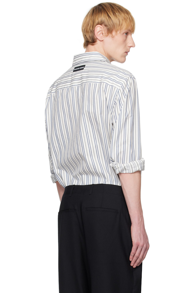 Cotton poplin shirt. Stripes throughout.

· Spread collar
· Button closure
· Buttoned French cuffs
· Logo patch at back yoke

Supplier color: Regenerated striped poplin off white
