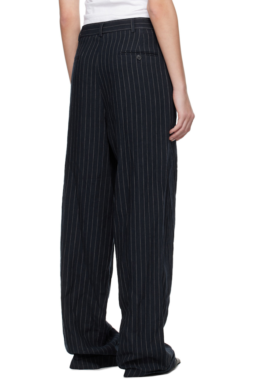 Linen hopsack trousers. Pinstripes throughout. 

· Belt loops
· Four-pocket styling
· Offset button fly 
· Pleats at front 
· Rolled cuffs

Supplier color: Dark navy stripe