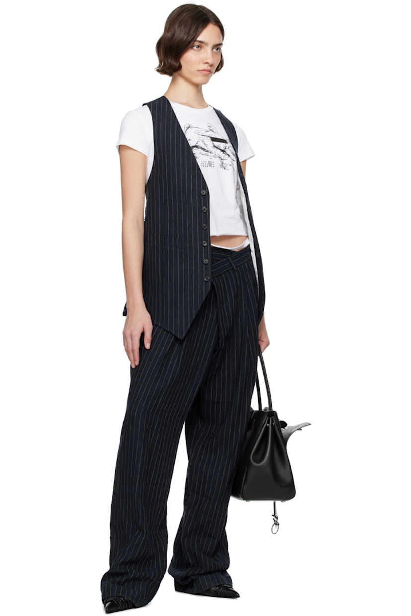 Linen hopsack trousers. Pinstripes throughout. 

· Belt loops
· Four-pocket styling
· Offset button fly 
· Pleats at front 
· Rolled cuffs

Supplier color: Dark navy stripe