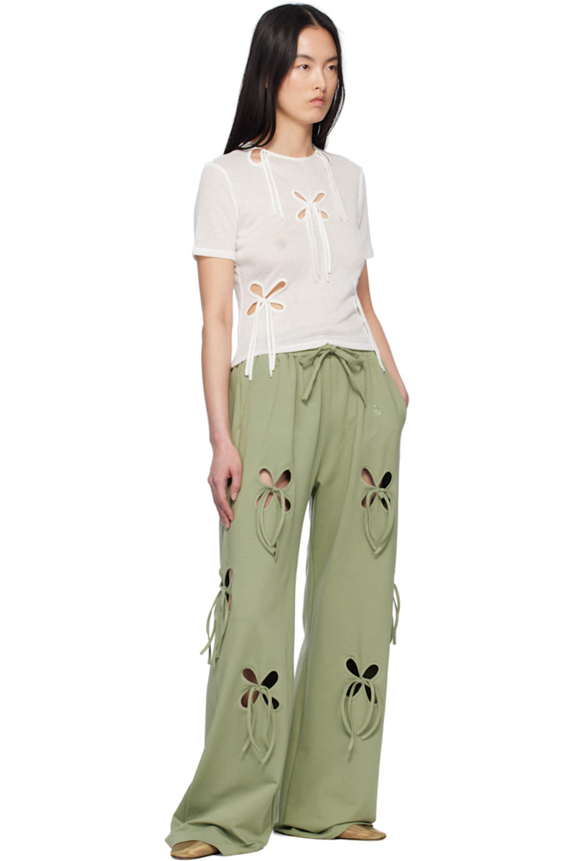 Loose-fit stretch cotton jersey lounge pants. Floral cutouts with self-tie fastening throughout. 

· Drawstring at elasticized waistband
· Two-pocket styling
· Logo embroidered at front

Supplier color: Swamp