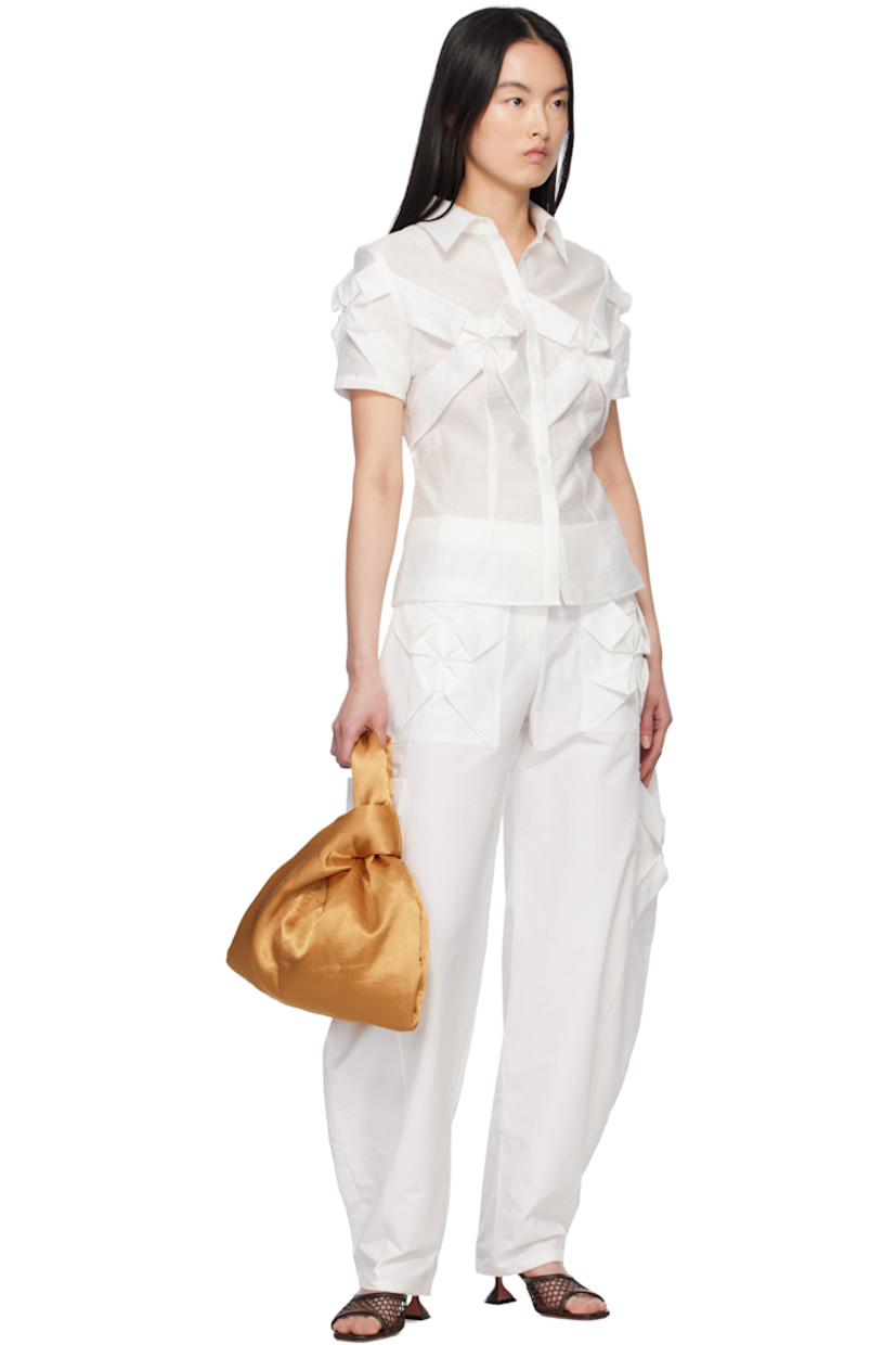Nylon- and cotton-blend twill cargo pants. 

· Mid-rise
· Belt loops
· Four-pocket styling
· Hand-stitched floral smocking at pockets
· Zip fly
· Cargo pockets at curved outseams

Supplier color: White