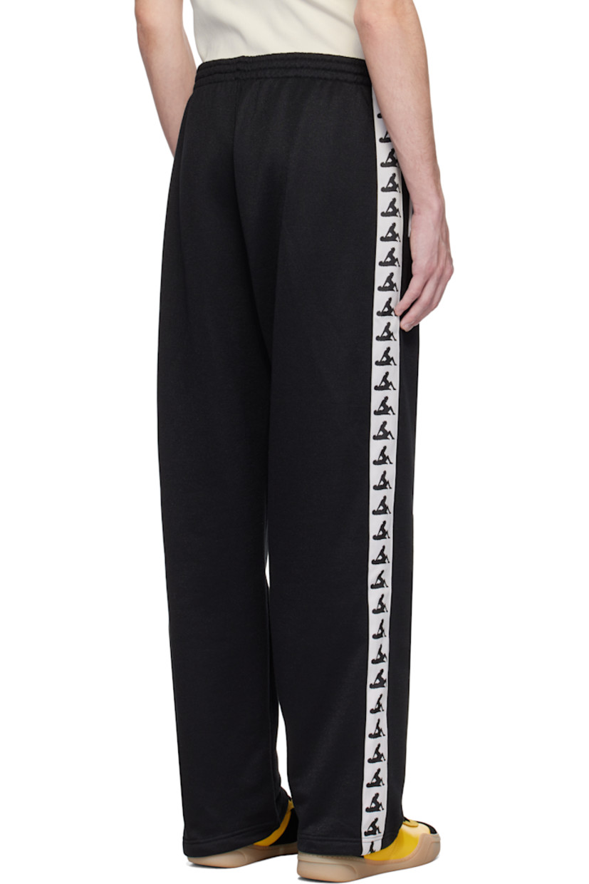 French terry sweatpants. 

· Concealed drawstring at elasticized waistband
· Two-pocket styling
· Graphic embroidered at front
· Graphic-woven trim at outseams

Available exclusively at SSENSE.

Supplier color: Black