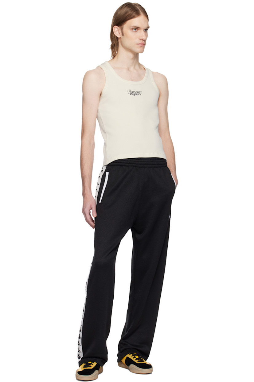 French terry sweatpants. 

· Concealed drawstring at elasticized waistband
· Two-pocket styling
· Graphic embroidered at front
· Graphic-woven trim at outseams

Available exclusively at SSENSE.

Supplier color: Black