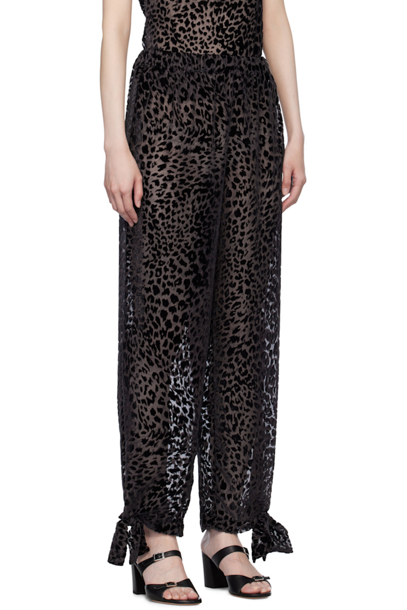 Semi-sheer viscose- and silk-blend chiffon trousers. Leopard pattern flocked throughout.

· Elasticized waistband
· Bow accent and press-stud fastening at cuffs

Supplier color: Brown Black
