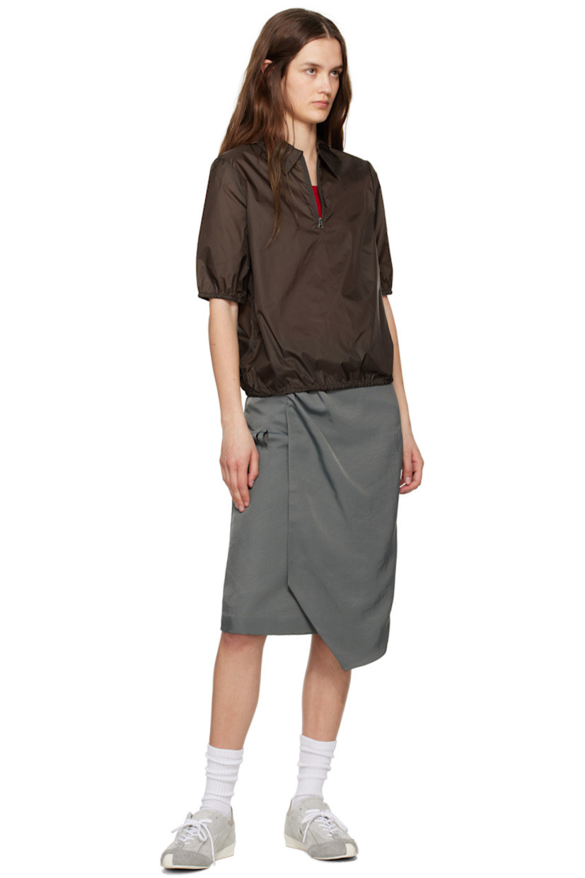 Nylon twill midi skirt.

· Wrap construction
· Two-pocket styling
· Gathering at front
· Belt loop slits at front and back
· Asymmetrical hem
· Frayed logo flag at back
· Central vent and raw edge at back hem
· Partial satin lining

Supplier color: Charcoal
