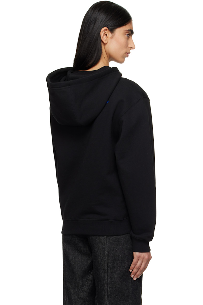 French terry hoodie.

· Drawstring at hood
· Logo and text printed at chest
· Graphic bonded at chest
· Kangaroo pocket
· Rib-knit hem and cuffs
· Dropped shoulders
· Frayed logo flag with topstitching at back

Supplier color: Noir