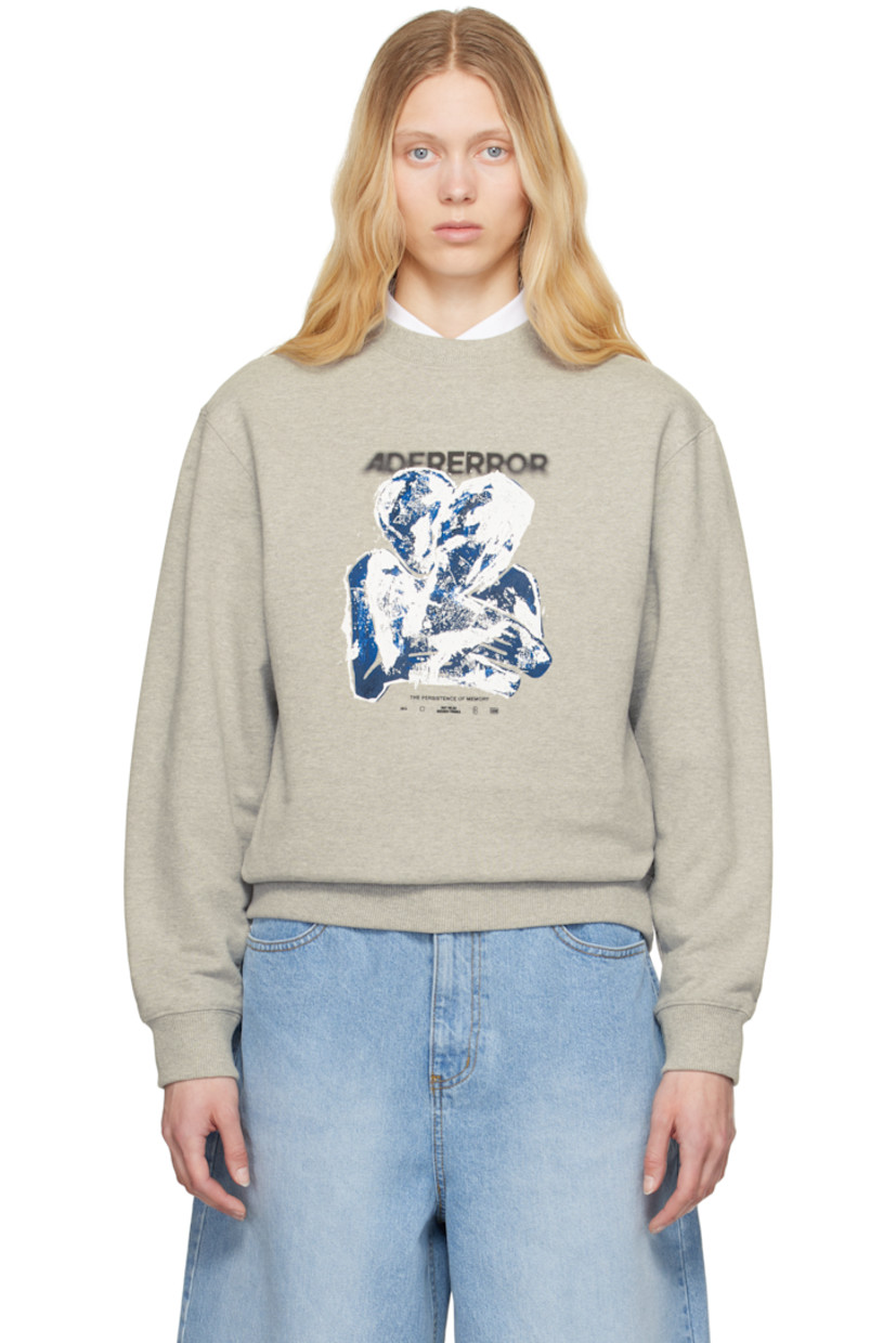 French terry sweatshirt.

· Rib-knit crewneck, hem, and cuffs
· Logo and text printed at front
· Graphic bonded at front
· Dropped shoulders
· Frayed flag at back shoulder

Supplier color: Grey