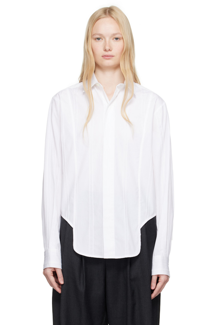 Plain-woven cotton shirt. Pinched seams throughout.

· Spread collar
· Concealed button closure
· Asymmetric cropped hem
· Pleats at buttoned barrel cuffs
· Frayed flag with topstitching at back yoke
· Box pleats at back yoke

Supplier color: White