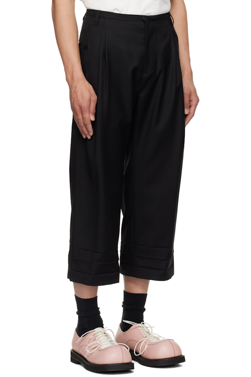 Wool twill trousers. 

· Belt loops
· Six-pocket styling
· Zip fly
· Pleats at front waistband
· Creasing at cropped cuffs
· Darts at back waistband
· Frayed flag with topstitching at back

Supplier color: Noir
