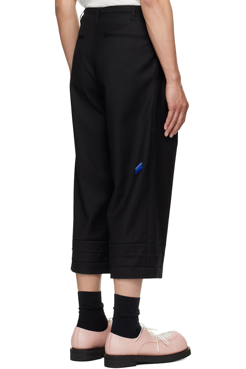 Wool twill trousers. 

· Belt loops
· Six-pocket styling
· Zip fly
· Pleats at front waistband
· Creasing at cropped cuffs
· Darts at back waistband
· Frayed flag with topstitching at back

Supplier color: Noir