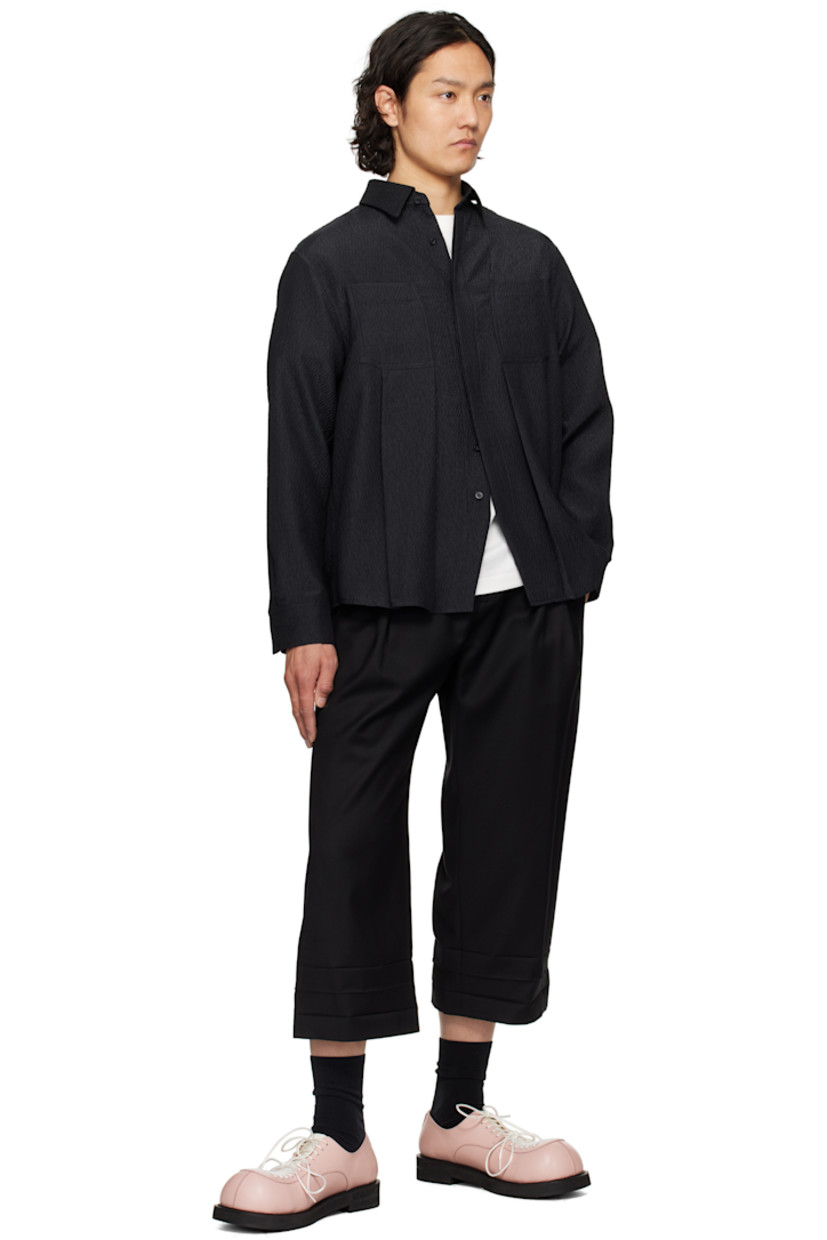 Wool twill trousers. 

· Belt loops
· Six-pocket styling
· Zip fly
· Pleats at front waistband
· Creasing at cropped cuffs
· Darts at back waistband
· Frayed flag with topstitching at back

Supplier color: Noir