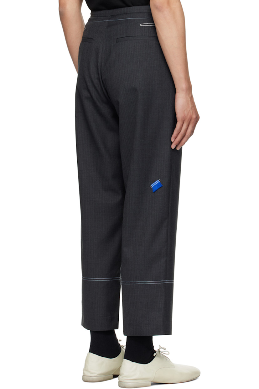 Wool-blend delaine trousers. 

· Mid-rise
· Four-pocket styling
· Zip fly
· Darts with topstitching at back waistband
· Frayed flag with topstitching at back
· Contrast stitching in white

Supplier color: Grey