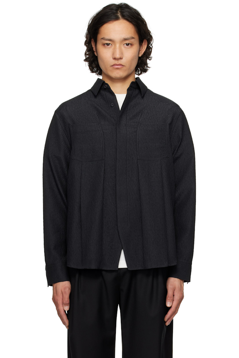 Oversized and crinkled plain-woven polyester shirt.

· Spread collar
· Button closure
· Box pleat at patch pockets
· Concealed double-button barrel cuffs
· Twin pleats with topstitching at back yoke
· Frayed appliqué at back hem

Supplier color: Noir