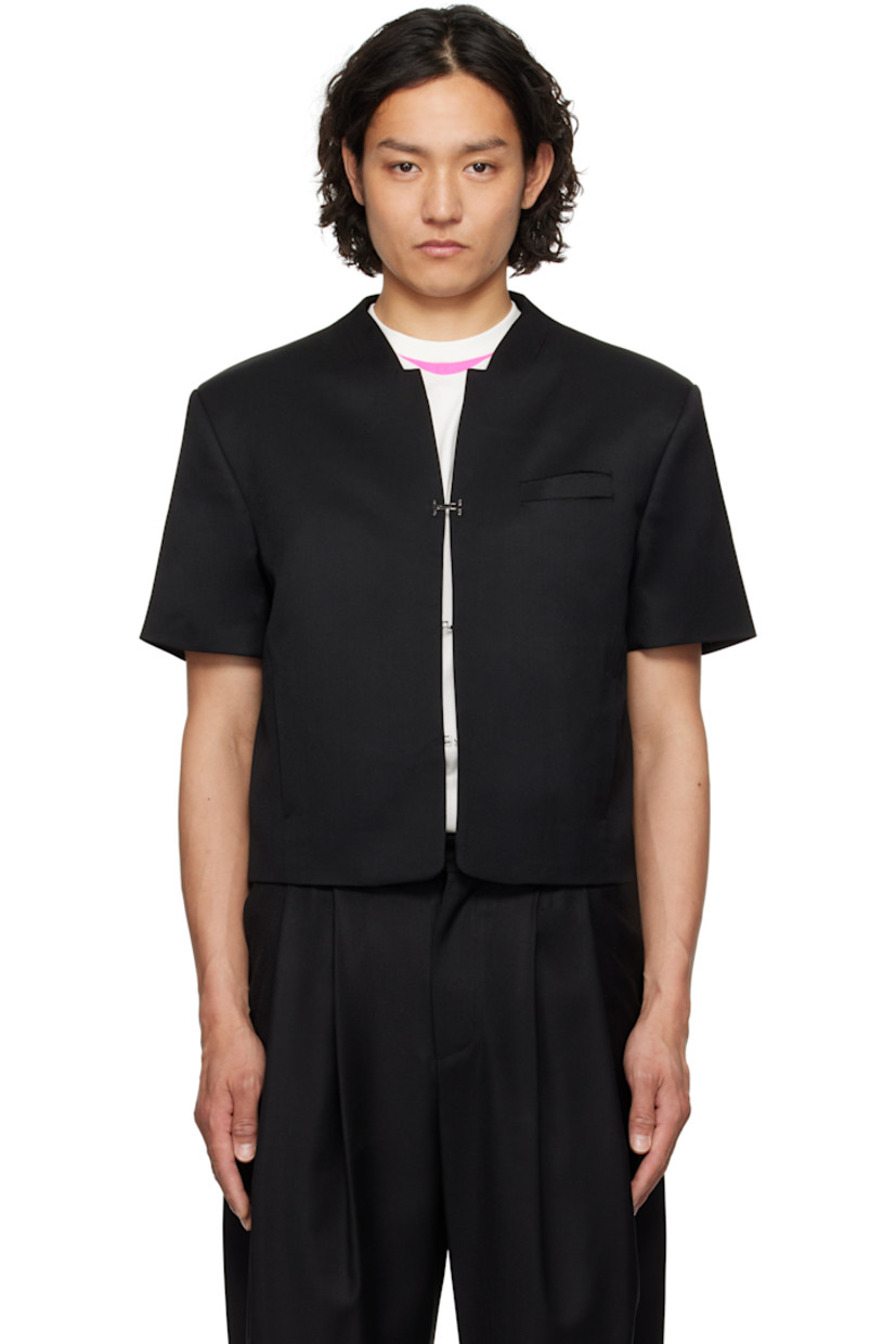Wool twill overshirt. 

· Notched collar
· Hook-eye closure
· Ripped detailing at chest 
· Welt pockets
· Padded shoulders
· Frayed flag with topstitching at back
· Welt pocket at interior 
· Full logo-woven satin lining 

Supplier color: Black