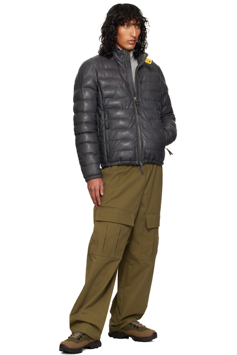 Insulated and quilted vegetable-tanned lambskin jacket.

· Press-stud tab at stand collar
· Two-way zip closure
· Zip pockets
· Elasticized hem and cuffs
· Vent at underarms
· Embroidered logo patch at sleeve
· Patch pockets at interior
· Full quilted taffeta lining

Supplier color: Phantom