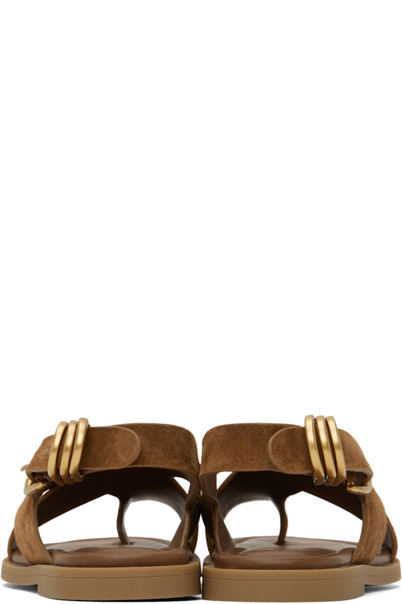 Suede flat sandals in brown. 

· LWG-certified
· Open toe
· Crisscrossing straps with integrated toe strap 
· D-rings at pin-buckle ankle strap
· OrthoLite® Lazy-Hybrid™ and OrthoLite® Recycled footbed
· Rubber sole

Supplier color: Umber suede