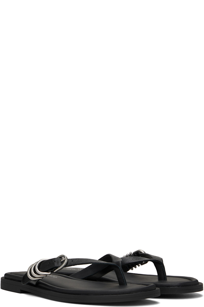 Grained goatskin flat sandals in black. 

· LWG-certified
· Open toe
· Pin-buckle thong-style strap at vamp
· D-rings at strap
· OrthoLite® Lazy-Hybrid™ and OrthoLite® Recycled footbed
· Rubber sole

Supplier color: Black