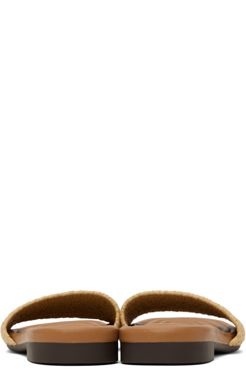Woven slip-on flat sandals in tan.

· Open square toe
· Embroidered logo at vamp
· Logo stamp at quilted faux-leather footbed
· Treaded rubber sole

Supplier color: Natural