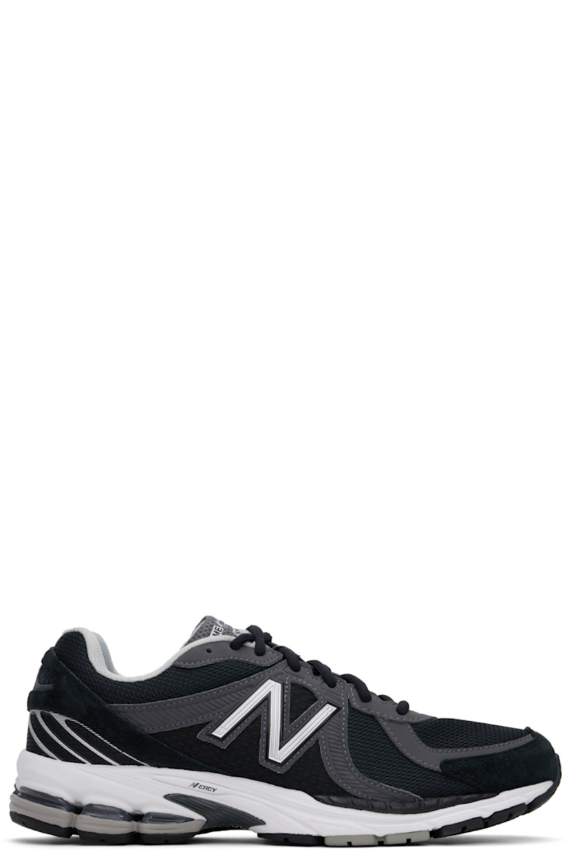 Low-top paneled suede and mesh sneakers in black.

· Logo embossed at toe 
· Lace-up closure
· Logo printed at vamp
· Logo bonded at padded tongue
· Padded collar 
· Reflective logo appliqué at sides
· Mesh lining
· Treaded N-ergy and Stability Web technology sole

Part of the Comme des Garçons Homme x New Balance collaboration.

Supplier color: Black/Grey