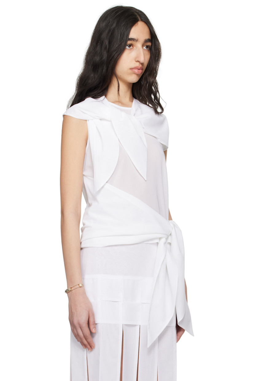 Sheer cotton voile blouse. 

· Integrated scarf-style trim at crewneck
· Self-tie overlay panel at hem 
· Button fastening at back collar
· Unlined

Supplier color: White