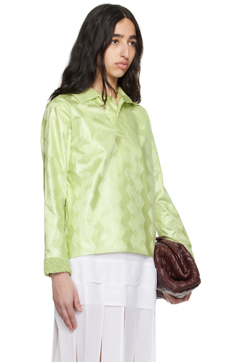 Cotton brocade polo. Jacquard graphic pattern throughout. 

· Shirring at spread collar and cuffs
· Two-button placket
· Tennis-tail hem 

Supplier color: Almond green