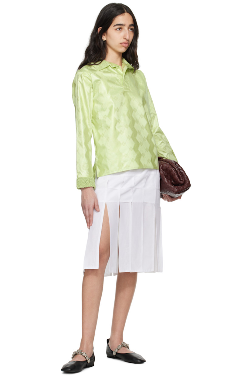 Cotton brocade polo. Jacquard graphic pattern throughout. 

· Shirring at spread collar and cuffs
· Two-button placket
· Tennis-tail hem 

Supplier color: Almond green