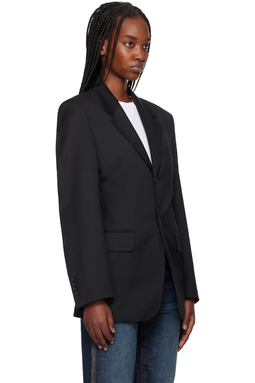 Polyester- and wool-blend twill blazer.

· Notched lapel
· Button closure
· Welt pocket at chest
· Flap pockets
· Padded shoulders
· Four-button surgeon's cuffs
· Central vent at back hem
· Welt pocket at interior
· Full satin lining

Supplier color: Black